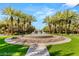 Beautiful water fountain with palm trees and lush landscaping, creating a serene community atmosphere at 2346 Villandry Ct, Henderson, NV 89074