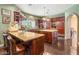 Gourmet kitchen featuring custom cabinetry, granite countertops, stainless steel appliances, and a central island at 2346 Villandry Ct, Henderson, NV 89074