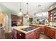 Open kitchen with island cooktop, custom cabinets, stainless appliances, and bar seating for entertaining at 2346 Villandry Ct, Henderson, NV 89074