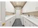 Functional laundry room featuring extensive cabinetry and modern appliances at 2346 Villandry Ct, Henderson, NV 89074