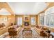 Comfortable living room featuring a cozy fireplace, plush sofas, and bright windows at 2346 Villandry Ct, Henderson, NV 89074