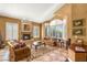 Inviting living room featuring a fireplace, plush seating, and large windows for natural light at 2346 Villandry Ct, Henderson, NV 89074