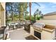 Outdoor kitchen with built-in grill and dining area, perfect for entertaining at 2346 Villandry Ct, Henderson, NV 89074