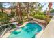 Resort-style pool and spa surrounded by lush landscaping, creating a private backyard oasis at 2346 Villandry Ct, Henderson, NV 89074