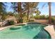 A beautiful pool with a built-in bar top, spa, and well-maintained landscaping offers a relaxing outdoor space at 2346 Villandry Ct, Henderson, NV 89074