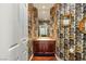 Unique powder room featuring bold wallpaper, a stylish mirror, and a modern vanity at 2346 Villandry Ct, Henderson, NV 89074