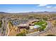 Aerial view shows the pool, landscaping, parking, and architectural complex at 2373 Ozark Plateau Dr, Henderson, NV 89044