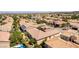 Wide aerial view of the neighborhood showcasing the tile roofs and mature landscaping of the surrounding houses at 2373 Ozark Plateau Dr, Henderson, NV 89044