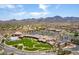 An aerial view of complex with desert and mountain views, lots of parking and landscaping at 2373 Ozark Plateau Dr, Henderson, NV 89044