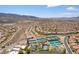 A lovely aerial view of a community with houses, tennis courts, and a swimming pool at 2373 Ozark Plateau Dr, Henderson, NV 89044