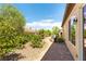 The backyard features pavers, lush plants, trees, a grill, and is perfect for entertaining at 2373 Ozark Plateau Dr, Henderson, NV 89044