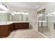 Primary bathroom includes a double vanity, a soaking tub, and a glass-enclosed shower at 2373 Ozark Plateau Dr, Henderson, NV 89044