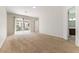 A large carpeted bedroom with neutral-colored walls and glass doors leading to the outside at 2373 Ozark Plateau Dr, Henderson, NV 89044