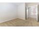 A bright carpeted bedroom featuring neutral walls and a white door that leads into another room at 2373 Ozark Plateau Dr, Henderson, NV 89044