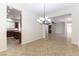 Open-concept dining area offering tile flooring and a modern chandelier at 2373 Ozark Plateau Dr, Henderson, NV 89044
