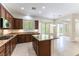 A bright kitchen with an island, granite countertops, wood cabinets, and tile flooring at 2373 Ozark Plateau Dr, Henderson, NV 89044