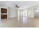 Spacious living room featuring tile flooring, a ceiling fan, and abundant natural light from the French doors at 2373 Ozark Plateau Dr, Henderson, NV 89044