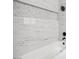 Detail of the tile in a modern bathroom featuring a soaking tub and black hardware at 2409 Alpine Meadows Ave, Henderson, NV 89074