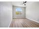 This bedroom features gray walls, wood floors, and a modern ceiling fan at 2409 Alpine Meadows Ave, Henderson, NV 89074