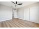 This bedroom features gray walls, wood floors, closet and access to the bathroom at 2409 Alpine Meadows Ave, Henderson, NV 89074