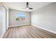 This bedroom has gray walls, wood floors, ceiling fan and plenty of room at 2409 Alpine Meadows Ave, Henderson, NV 89074