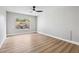 The bedroom is bright and has a ceiling fan, wood floors and a view of the backyard at 2409 Alpine Meadows Ave, Henderson, NV 89074