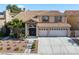 Charming two-story home featuring a tile roof and a well-maintained landscaped front yard at 2409 Alpine Meadows Ave, Henderson, NV 89074