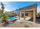 Exterior backyard view features covered patio, rock waterfall feature, and lagoon style pool at 2409 Alpine Meadows Ave, Henderson, NV 89074