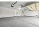 Clean two-car garage featuring painted floors and walls, an updated door, and a water heater at 2409 Alpine Meadows Ave, Henderson, NV 89074