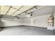 Spacious and clean two-car garage with painted floor and walls, equipped with an updated garage door and a water heater at 2409 Alpine Meadows Ave, Henderson, NV 89074