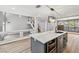 View of gray kitchen island with sink, dishwasher, oven and white countertops at 2409 Alpine Meadows Ave, Henderson, NV 89074