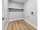 The laundry room has hard wood floors, gray walls and is ready for a washer and dryer at 2409 Alpine Meadows Ave, Henderson, NV 89074
