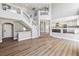 Bright living room showcases staircase and open access to kitchen at 2409 Alpine Meadows Ave, Henderson, NV 89074