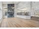Bright, open-concept living area features a floor-to-ceiling fireplace and hardwood floors at 2409 Alpine Meadows Ave, Henderson, NV 89074