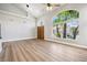 Light-filled living room featuring hardwood floors, high ceilings, and a view of the front yard at 2409 Alpine Meadows Ave, Henderson, NV 89074
