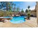 Backyard pool area featuring rock waterfall feature, a spa, and ample deck space at 2409 Alpine Meadows Ave, Henderson, NV 89074