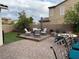 Charming backyard with patio seating, an artificial lawn, and lush landscaping at 242 Homeward Way, Henderson, NV 89011