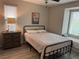 Cozy bedroom with a bed, nightstand, and window seat at 242 Homeward Way, Henderson, NV 89011