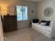 Neutral bedroom showcasing daybed, wood dresser, and natural light at 242 Homeward Way, Henderson, NV 89011