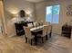 Charming dining area featuring a wooden table set, a sideboard, and ample natural light from a window at 242 Homeward Way, Henderson, NV 89011