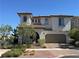 Charming two-story home featuring a tile roof, arched entry, and a well-manicured front yard at 242 Homeward Way, Henderson, NV 89011