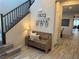 Inviting foyer featuring a wooden bench and staircase, offering a warm welcome into the home at 242 Homeward Way, Henderson, NV 89011