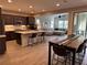 Open concept kitchen with an island, dark wood cabinetry, and adjacent dining and living spaces at 242 Homeward Way, Henderson, NV 89011