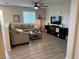 Comfortable living room features a sectional sofa, fireplace, TV, and plank flooring at 242 Homeward Way, Henderson, NV 89011