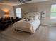 Comfortable main bedroom features a king bed, side tables, and plank floors at 242 Homeward Way, Henderson, NV 89011
