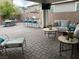 Spacious patio with outdoor seating, built-in bar, and mounted television at 242 Homeward Way, Henderson, NV 89011