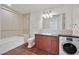 Well-lit bathroom featuring a tub-shower combo and convenient, front-loading washing machine at 2455 W Serene Ave # 851, Las Vegas, NV 89123