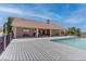 An expansive backyard features a covered patio, gray deck, and sparkling pool, perfect for outdoor enjoyment at 2780 Avenue Of The Stars, Pahrump, NV 89060