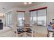 Breakfast nook featuring a round wood table with leather chairs, and two windows overlooking the exterior at 2780 Avenue Of The Stars, Pahrump, NV 89060