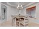 Bright dining room with a chandelier, natural light, and stylish neutral decor at 2780 Avenue Of The Stars, Pahrump, NV 89060
